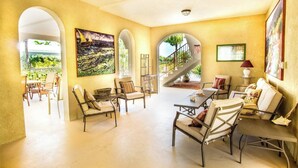 A spacious interior with a dining area, seating, and artwork. - Beachy Keen House 3/2 Water View Pool Home with Dock (Marathon)