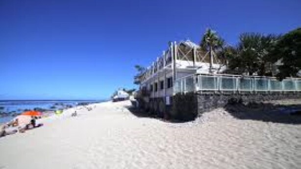 A beachfront hotel with a sandy beach, a pool, and a view of the ocean. - A stone's throw from the small beach of the Holy Land (Terre Sainte)