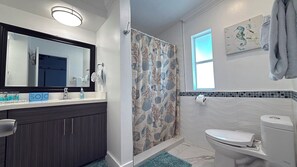 Bathtub, hair dryer, towels, toilet paper