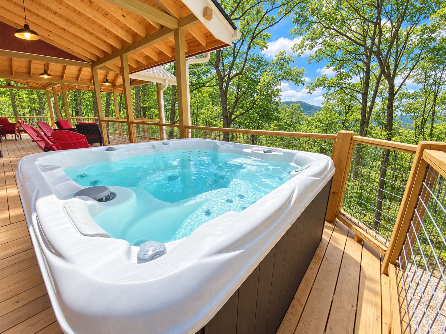 A hot tub on a wooden deck with a view of trees and mountains.
