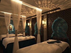 A room with two beds, each with a canopy, and ornate wall decorations. - Babylon Premium Hotel & Spa (Hanoi)