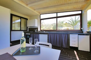 Enjoy meals in the kitchen with an oven and stove, and dine at the adjacent table and chairs.