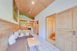 Un interior de madera con comedor, cocina y una puerta.