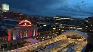 A train station with a large, illuminated sign reading "Union Station" and multiple tracks. - NEW!!Denvers ONLY centralTrain HUB "union station", downtown upscale living! (Denver)