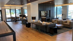 A modern living room with a pool table, comfortable seating, and a large TV. - NEW!!Denvers ONLY centralTrain HUB "union station", downtown upscale living! (Denver)