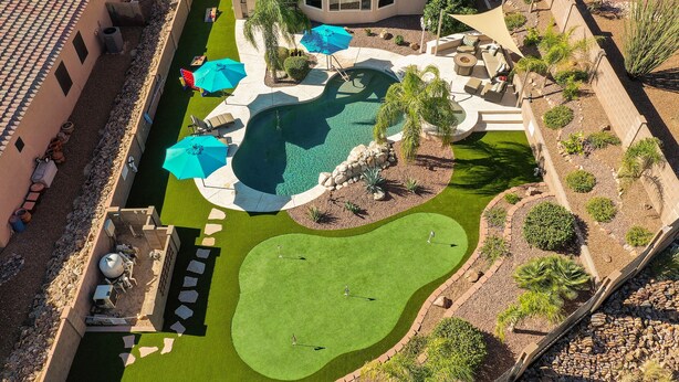 A rooftop pool area with a small pool, lounge chairs, and umbrellas. - Relaxing Vacation with Catalina Views & EV Charging 21315404 (Tucson)