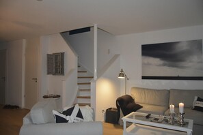 Flat-screen TV, DVD player, books, stereo