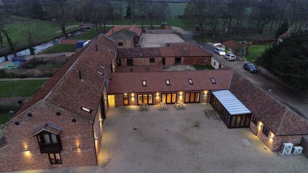 A large barn-like structure with multiple rooms and a covered outdoor area. - Kestrel Barn, Sleeps 10+2 (5 Bedrooms) (Norfolk)