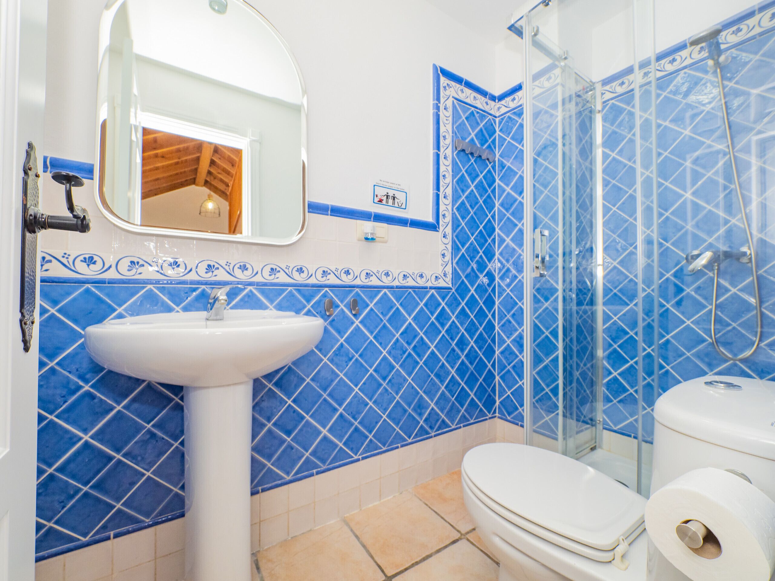 A bathroom with a sink, toilet, and shower.