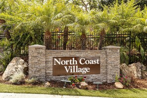 Experience the serene atmosphere of North Coast Village, surrounded by lush greenery and tropical plants.
