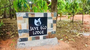 A sign for Jaye Eco Lodge with a logo and name. - Jaye Eco Lodge (Habarana)