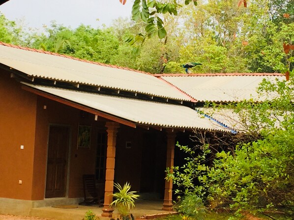 A traditional building with a tiled roof and a covered porch.