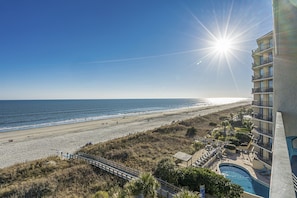 A beach view with a swimming pool and a building with balconies. - Oceanfront Waterpointe1 606-3b/2b-Sleep6-Balcony-WIFI-TV-Pool-Family Friendly (North Myrtle Beach)