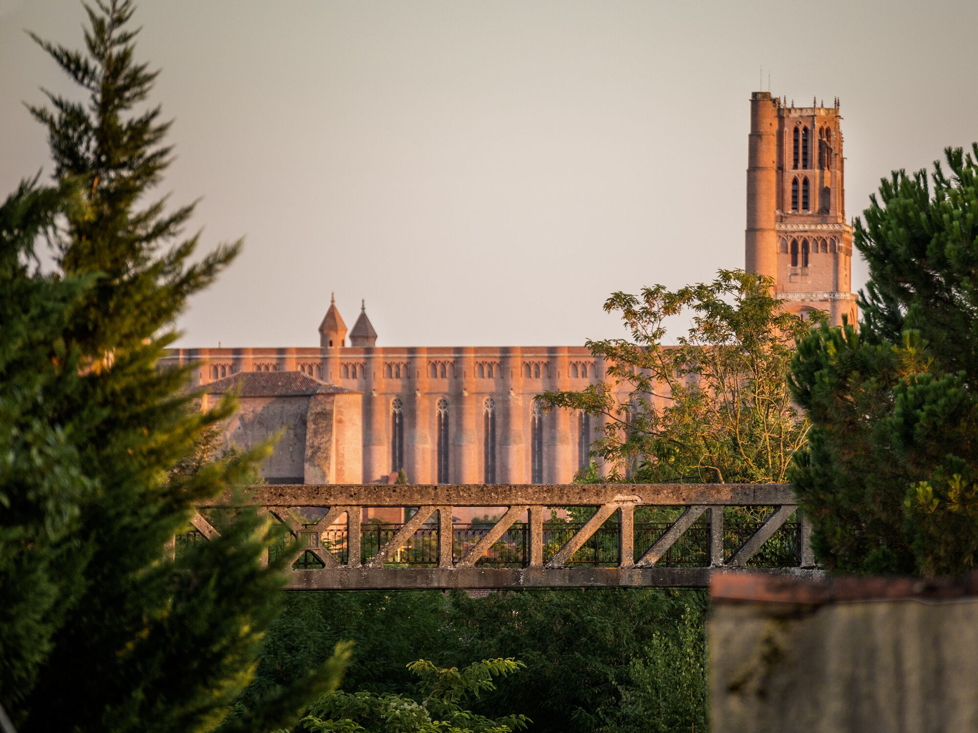 A historic building with a prominent tower and a bridge in the foreground.