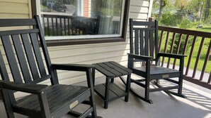 Two black Adirondack chairs on a porch with a window overlooking a street. - Cozy House, Pets Welcome, Minutes from Harrisburg (Duncannon)