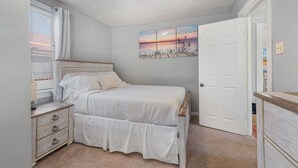 A bedroom with a bed, a nightstand, a dresser, a window with blinds, and a door. - Cozy House, Pets Welcome, Minutes from Harrisburg (Duncannon)