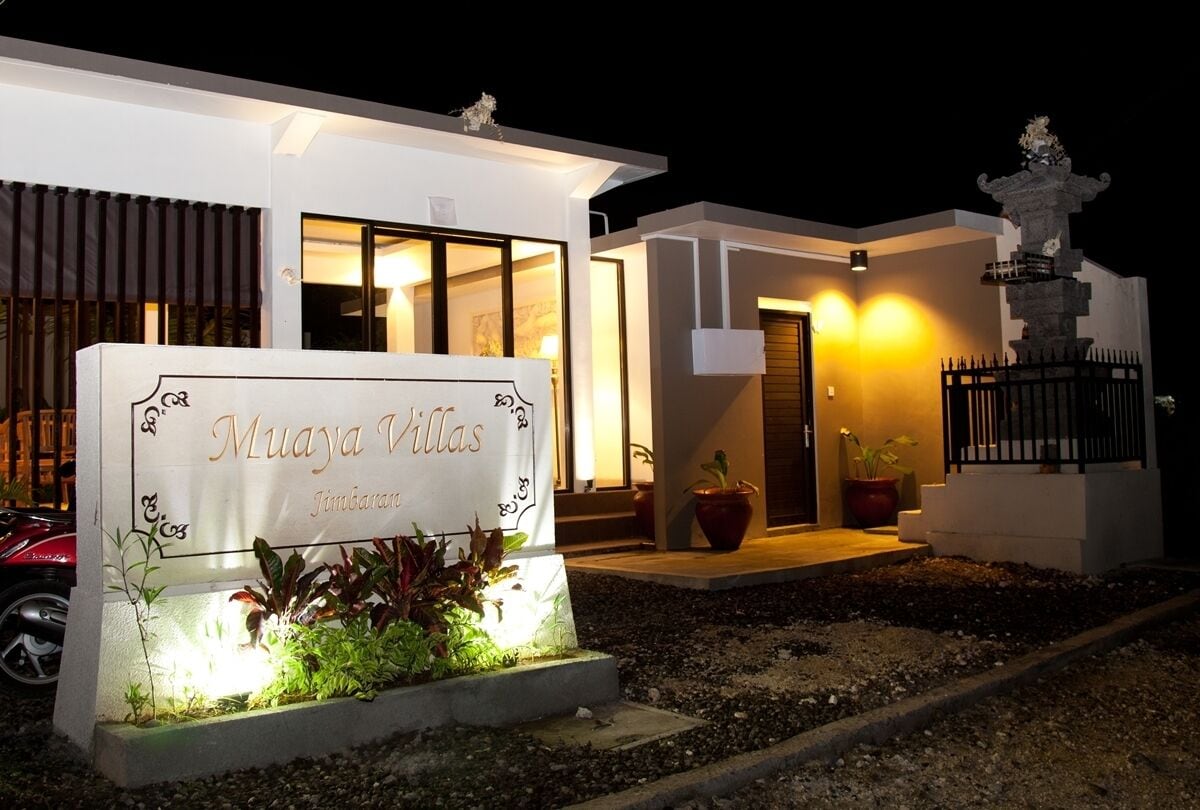 A modern building with a sign reading "Muaya Villas."