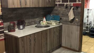 Fridge, microwave, cookware/dishes/utensils, cleaning supplies