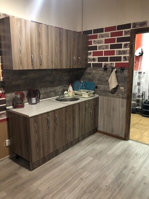 Fridge, microwave, cookware/dishes/utensils, cleaning supplies