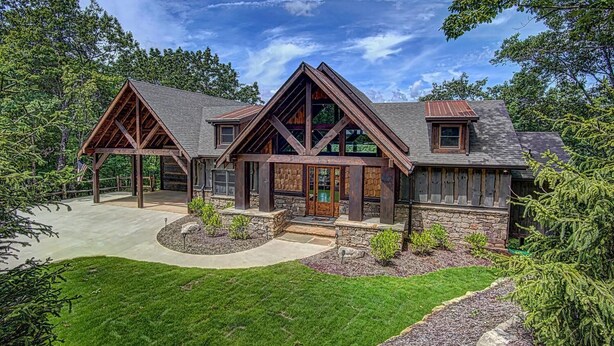 A log cabin with a stone foundation, wooden exterior, and a large front porch. - Luxury Cabin with amazing sunsets! Close to Downtown Blue Ridge! (Blue Ridge)