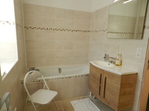 Bathtub, hair dryer, towels, soap