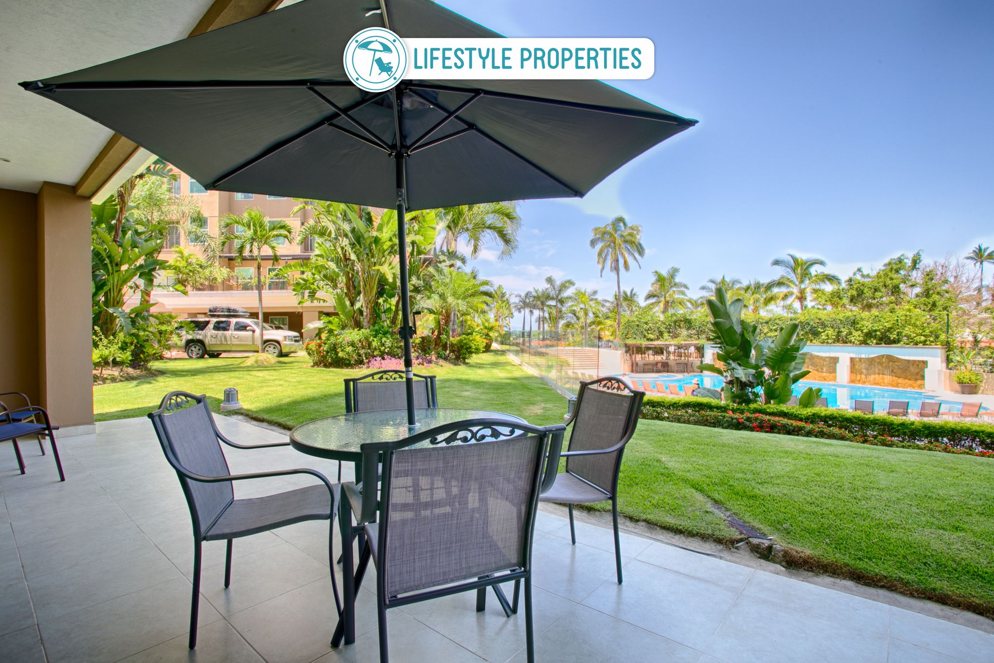 Large private patio overlooking pool, lush gardens