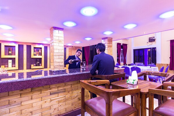 A restaurant with wooden furniture and a counter.