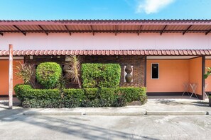 A building with a tiled roof, a brick wall, and a small window. - M.P Resort Krabi (Krabi)