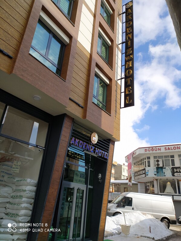 The exterior of Akdeniz Hotel with a clear view of the entrance and signage.