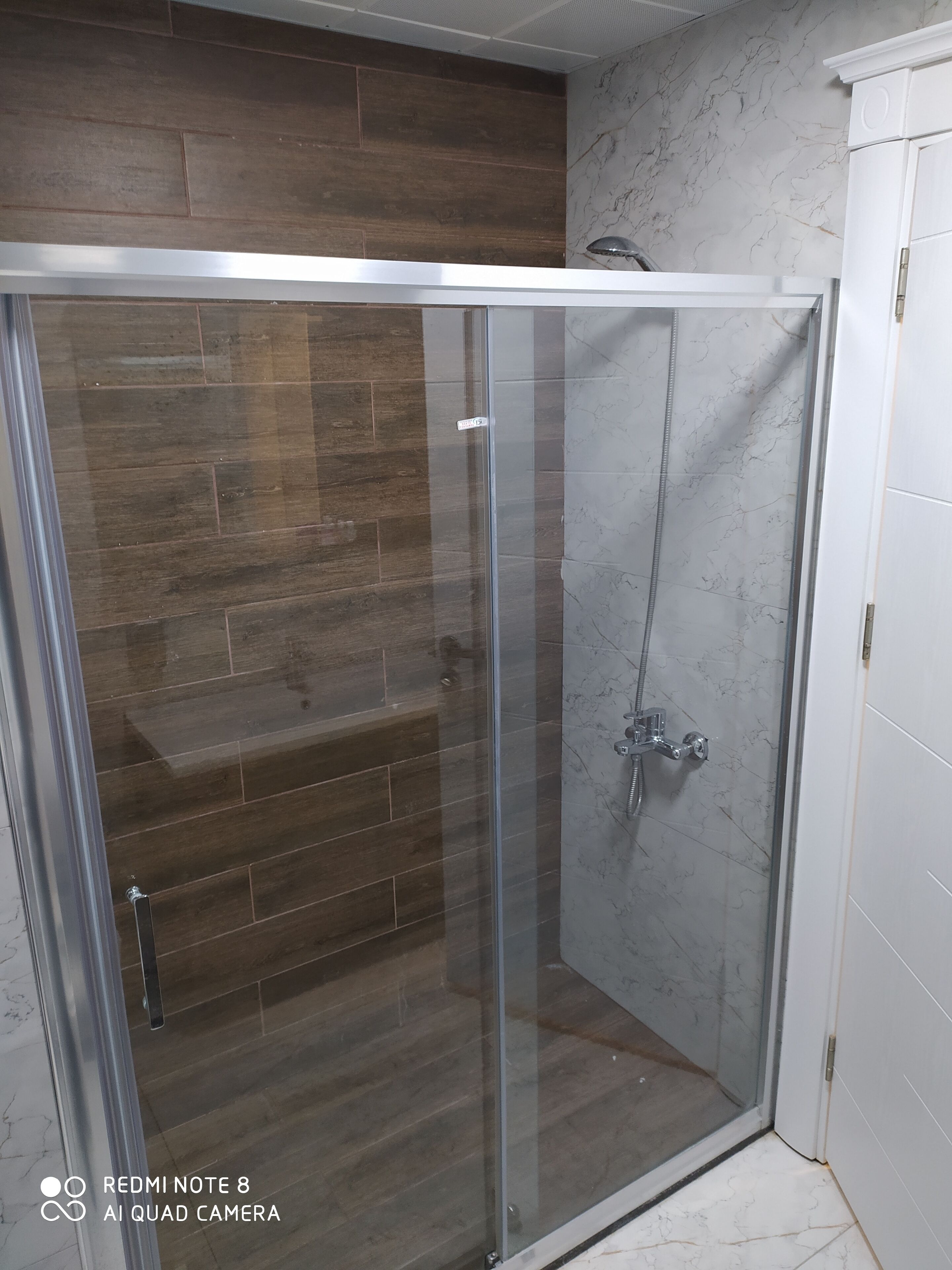 shower, hair dryer, slippers, towels