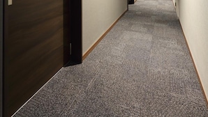 A hallway with carpeted floors, wooden doors, and recessed ceiling lighting. - Hotel Promote Hiroshima (Hiroshima)