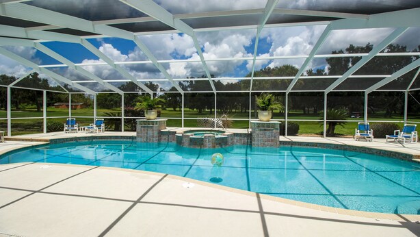 A covered swimming pool with a view of a golf course. - Spacious Modern Pool Home, Family & Golf Trips - 4727 4 Bedroom Home by RedAwning (Inverness)
