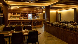 Un restaurante con decoración de madera, una zona de bar y servicio de buffet.