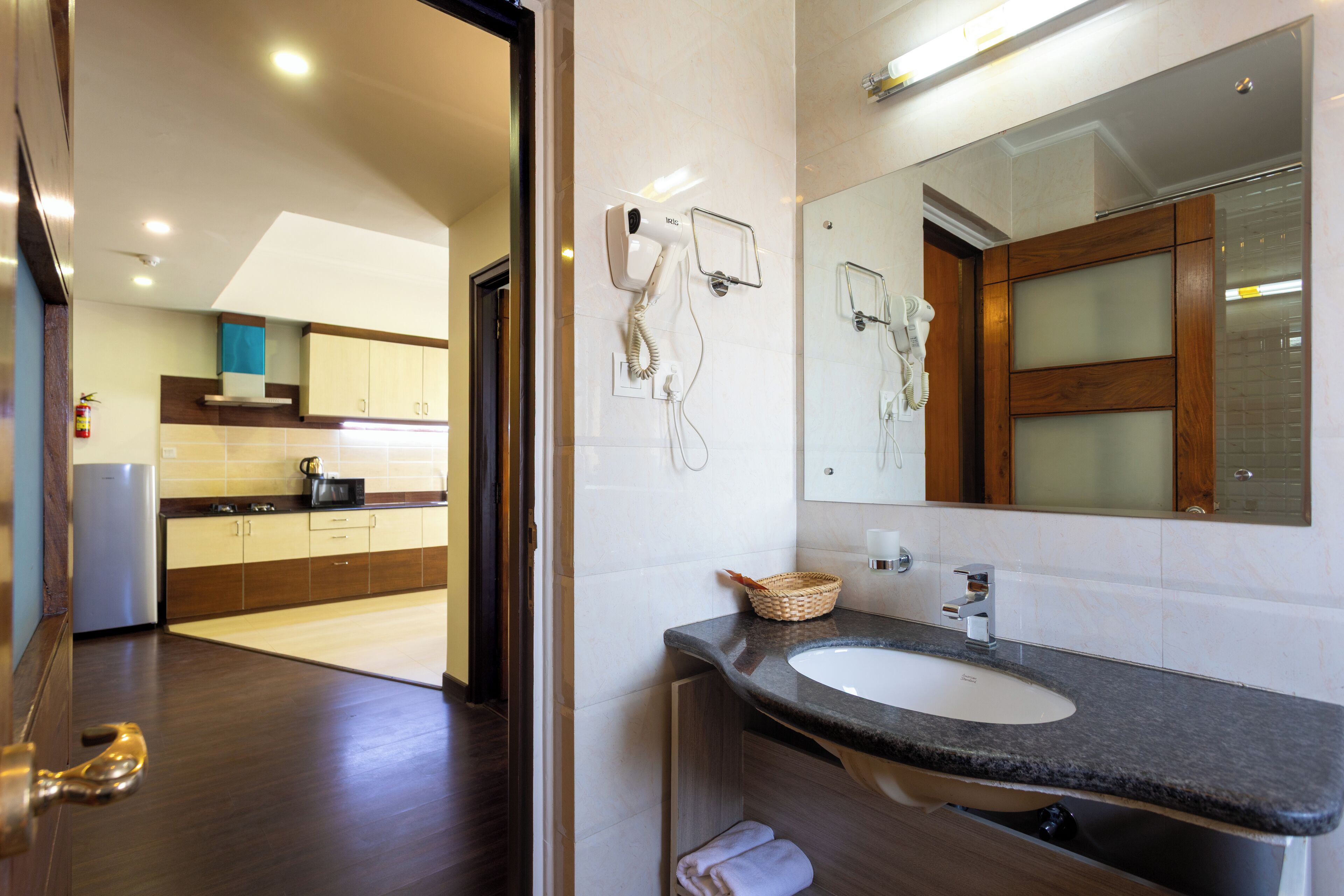 A modern bathroom with a sink, mirror, and hairdryer.