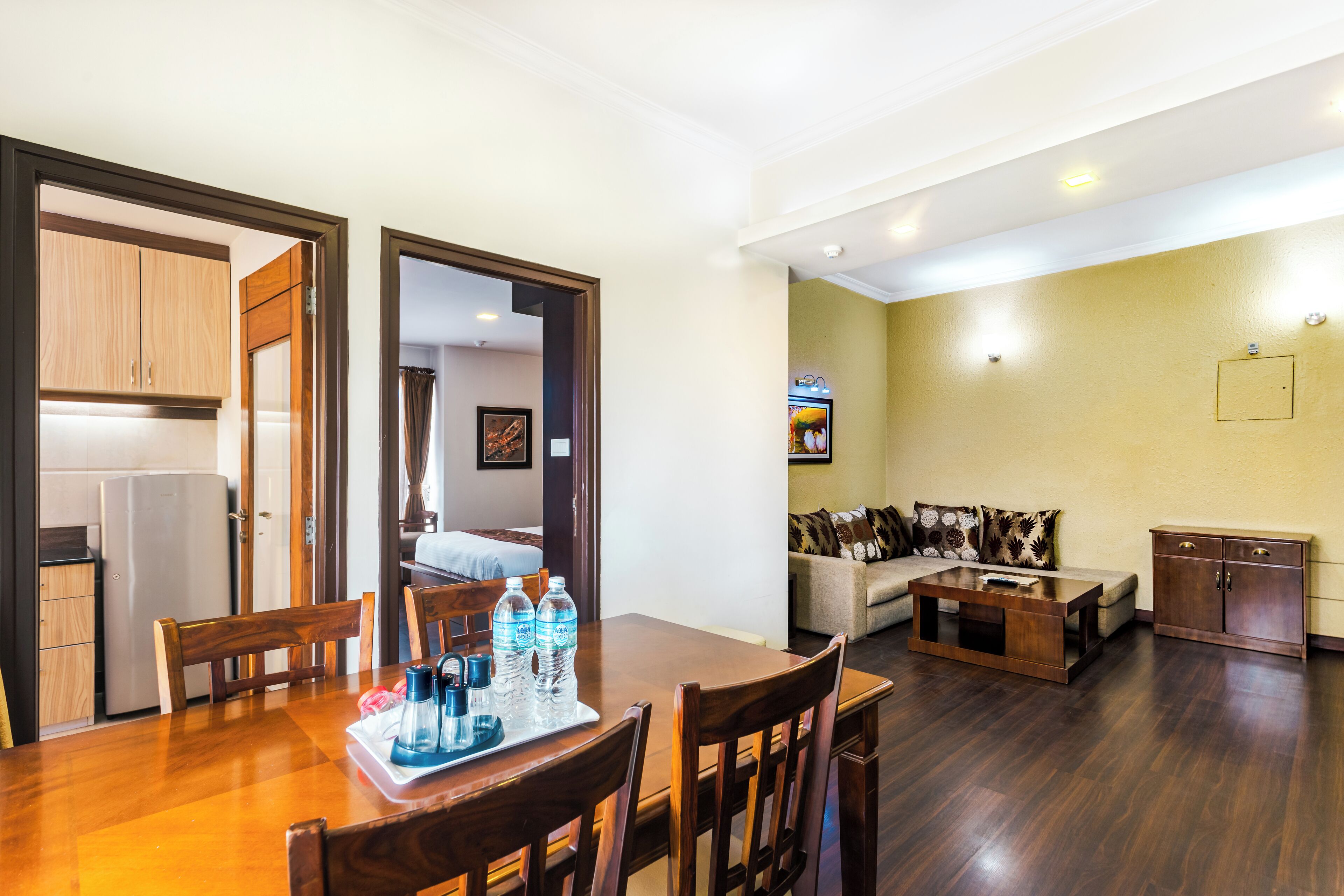 Un espacio habitable compacto con comedor, kitchenette y un sofá en la sala.