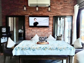Relax in this cozy retreat with a large flat-screen TV, coffee machine, and comfortable bed.