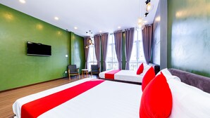 A hotel room with a large bed, a flat-screen TV, a small table, and a chair. - Seven A Hotel (Xuan Huong - Da Lat)