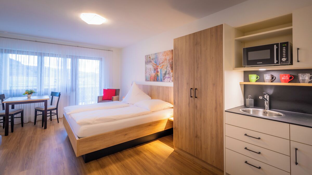 Premium bedding, desk, laptop workspace, blackout drapes
