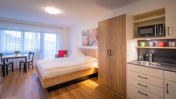 Premium bedding, desk, laptop workspace, blackout drapes