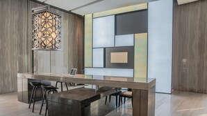 A modern kitchen with a central island, bar stools, and a decorative light fixture. - Jin Shi Hu Hotel (Kaohsiung)