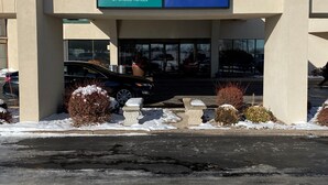 A building with a sign for Quality Inn and Suburban Extended Stay Hotel.