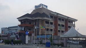 A multi-story building with a flat roof and a prominent sign on the top. - Blue Moon Beach Hotel & Resort (Lagos)