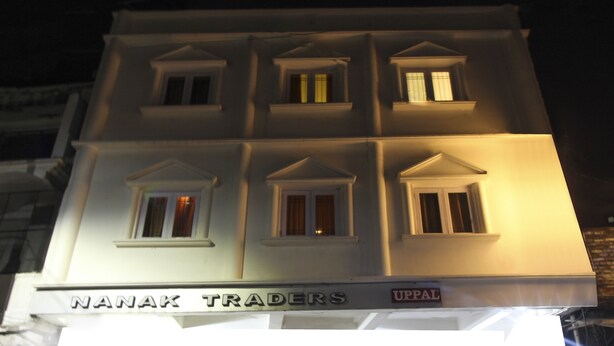 A building with multiple windows and a sign that reads "Nanak Traders." - Itsy Hotels Royal Monarch (Gorakhpur)