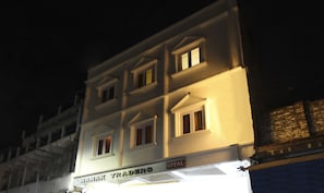 A multi-story building with illuminated signage for 'Nanak Traders'. - Itsy Hotels Royal Monarch (Gorakhpur)