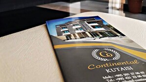 A brochure for Continental Kutaisi hotel with a modern building image. - Hotel Continental (Kutaisi)