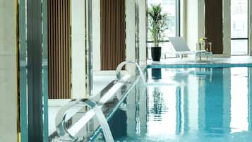 Indoor pool, open 7:00 AM to 9:00 PM, pool loungers, lifeguards on site
