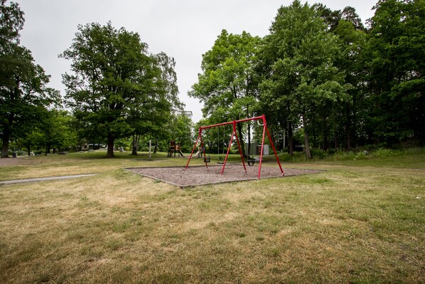 A park with a swing set and a playground.