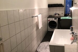 Bathtub, hair dryer, towels, soap