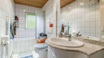 Bathtub, hair dryer, towels, soap