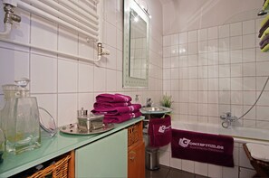 Bathtub, hair dryer, towels, soap